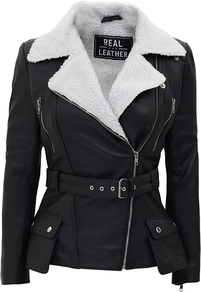 Black faux leather moto jacket with a white sherpa fleece collar, featuring a zippered front, belted waist, and side pockets, shown on a white background.