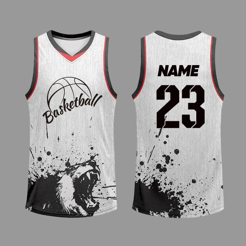 Customizable basketball jersey mockup showing front and back views on a blue gradient background. The jersey has a white textured body with black and red trim, a black basketball graphic with the word 'Basketball', a roaring lion print near the hem, and customizable text 'NAME' and '23' on the back.