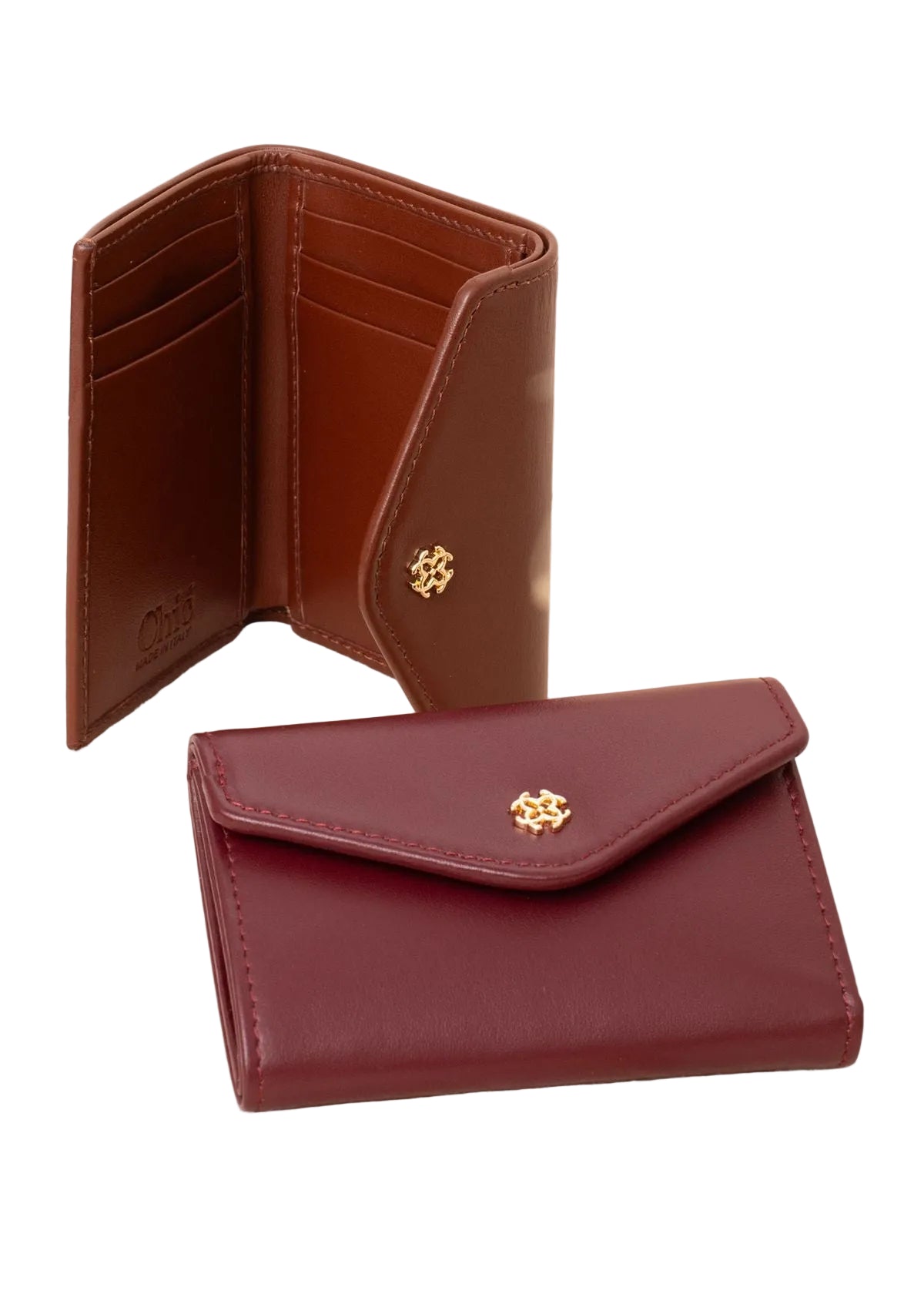 Two leather wallets displayed on a light beige textured surface. The front wallet is closed in a deep burgundy red with a gold-tone flower emblem on the flap.