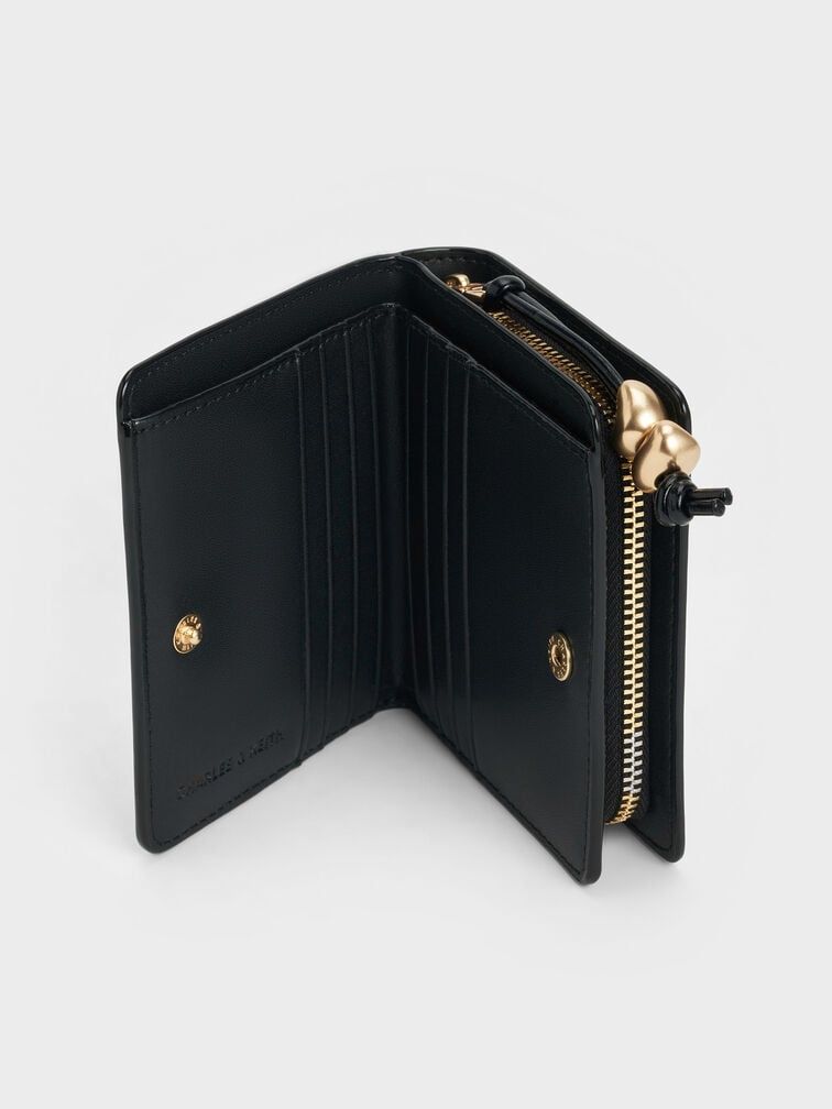Black wallet with gold accents on a white background